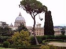 Central dome of St. Peter's in the Vatican City, palace of the Governatorate to r., northeastern Rome in background. View from the Papal Gardens.